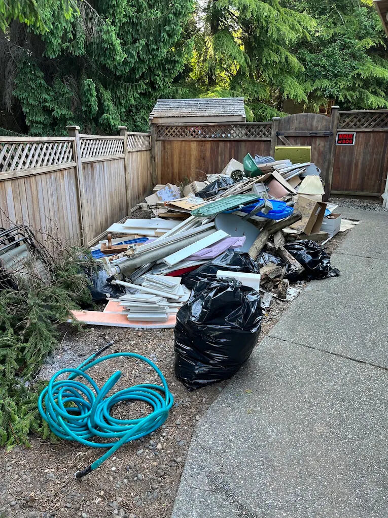 Fencing and yard materials piled for hauling