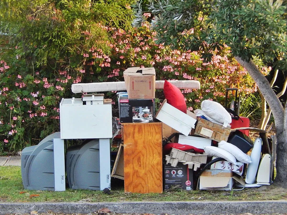 Household junk and yard waste staged curbside for pickup