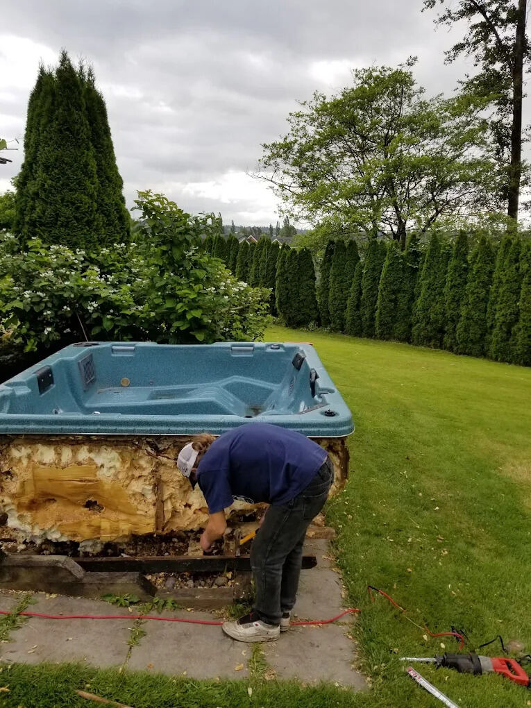 Red River crew removing an old hot tub during a backyard cleanout in Winnipeg