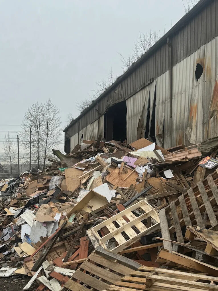 Large-scale warehouse debris pile cleared during a commercial cleanout
